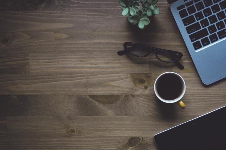 Work desk with a laptop and a cup of coffee