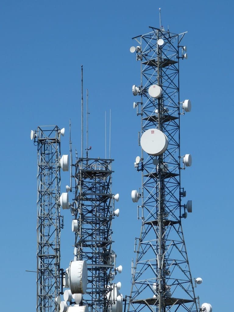 Communication tower fitted with microwave dishes used for point-to-point wireless links